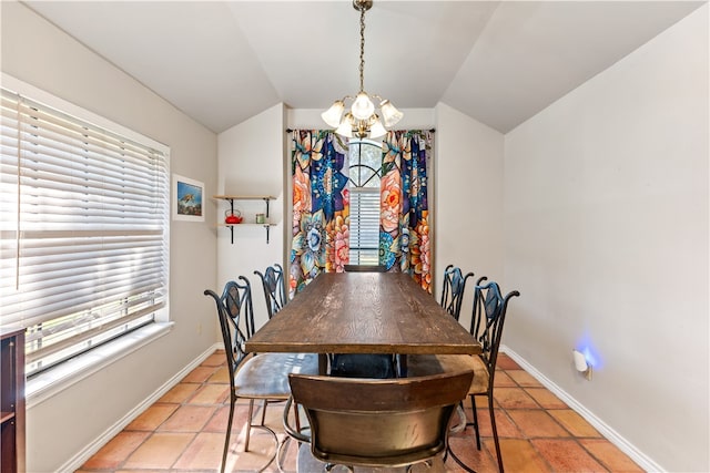 dining area with a wealth of natural light, tile patterned flooring, lofted ceiling, and a notable chandelier