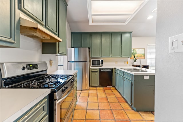 kitchen featuring appliances with stainless steel finishes, sink, and green cabinetry