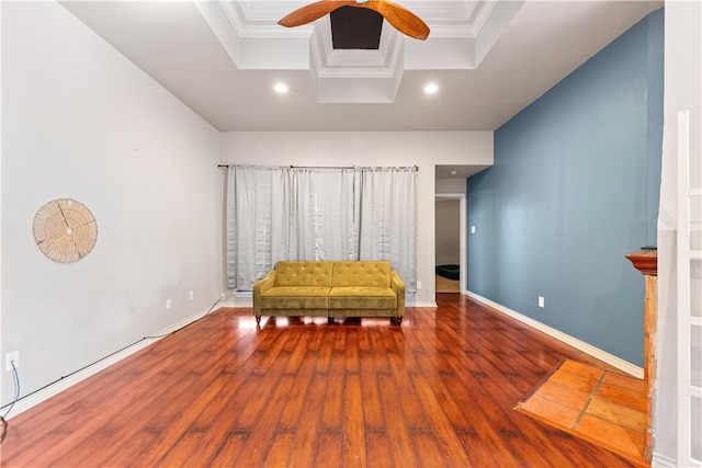 unfurnished room featuring hardwood / wood-style floors, ceiling fan, a raised ceiling, and ornamental molding