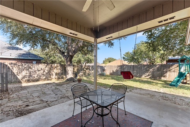 view of patio featuring a playground and ceiling fan