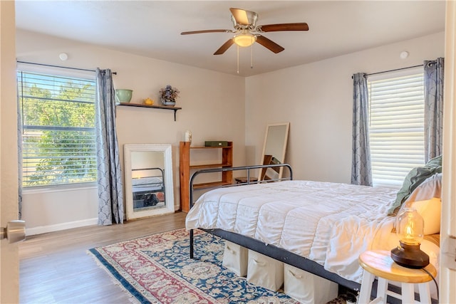 bedroom with light hardwood / wood-style floors and ceiling fan