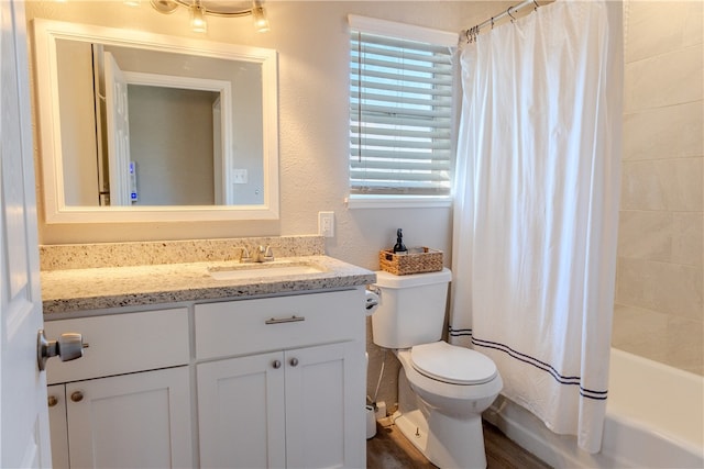 full bathroom featuring shower / bath combo, hardwood / wood-style floors, vanity, and toilet