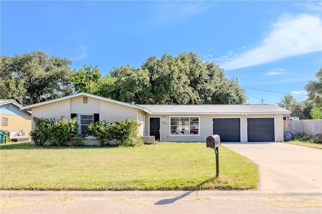 ranch-style home featuring a front lawn and a garage