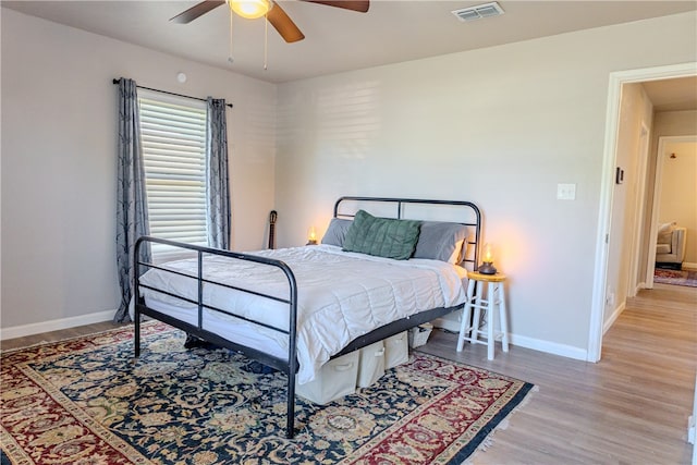 bedroom with light hardwood / wood-style flooring and ceiling fan