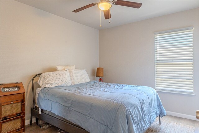 bedroom with wood-type flooring and ceiling fan