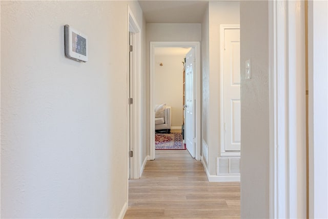 corridor with light wood-type flooring