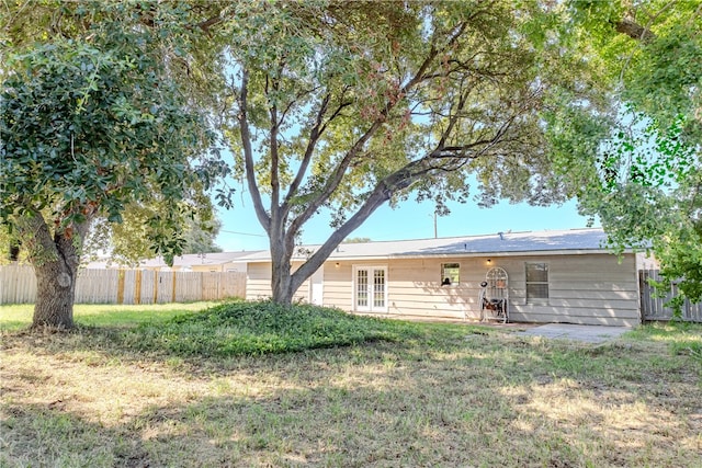 rear view of property with a yard