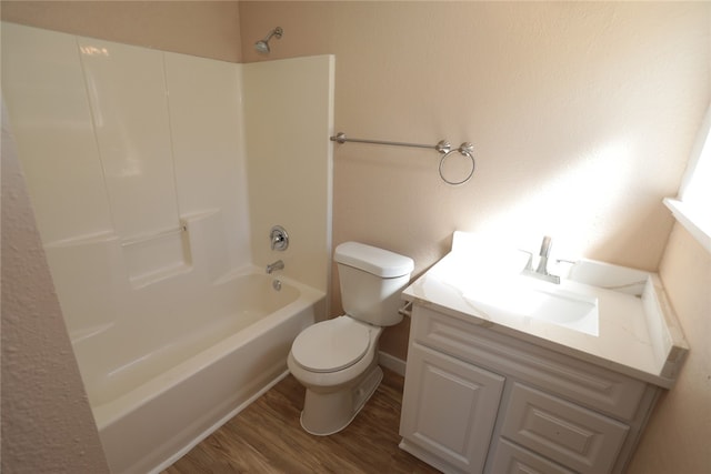 full bathroom with hardwood / wood-style floors, vanity, toilet, and tub / shower combination