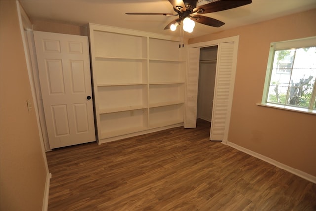 unfurnished bedroom with dark wood-type flooring, ceiling fan, and a closet