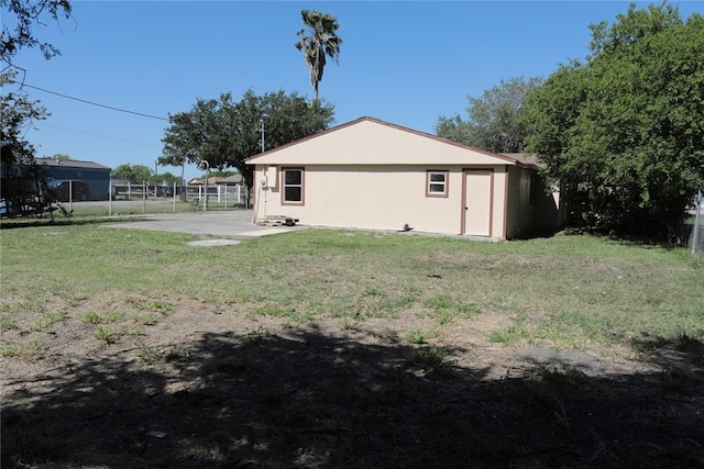 rear view of property with a lawn