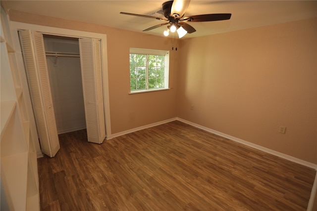 unfurnished bedroom featuring ceiling fan, dark hardwood / wood-style floors, and a closet