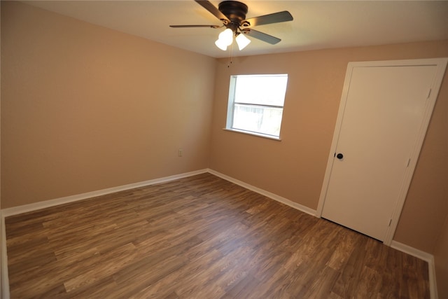 spare room featuring ceiling fan and dark hardwood / wood-style floors