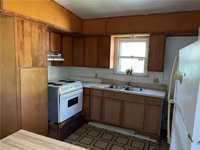 kitchen featuring white appliances and sink