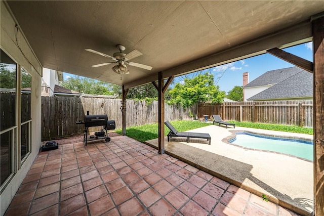 view of patio with a fenced backyard, a fenced in pool, ceiling fan, and grilling area