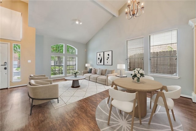 dining area with wood finished floors, beamed ceiling, baseboards, high vaulted ceiling, and a notable chandelier