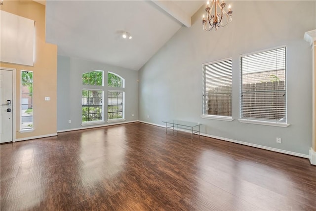 unfurnished living room featuring baseboards, high vaulted ceiling, a notable chandelier, and wood finished floors