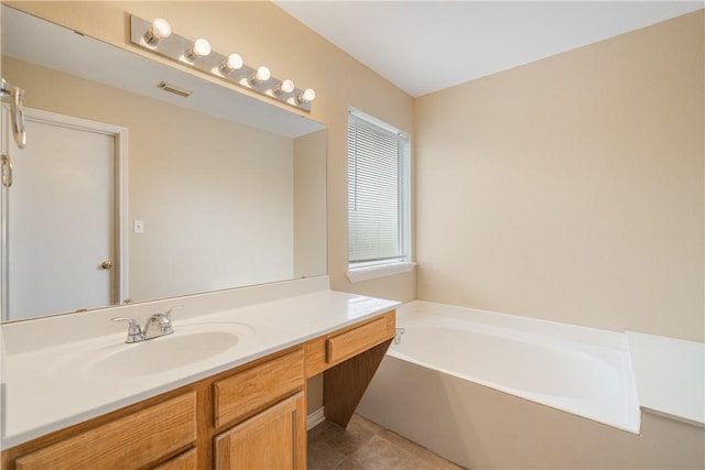 bathroom featuring vanity, tile patterned floors, a bath, and visible vents