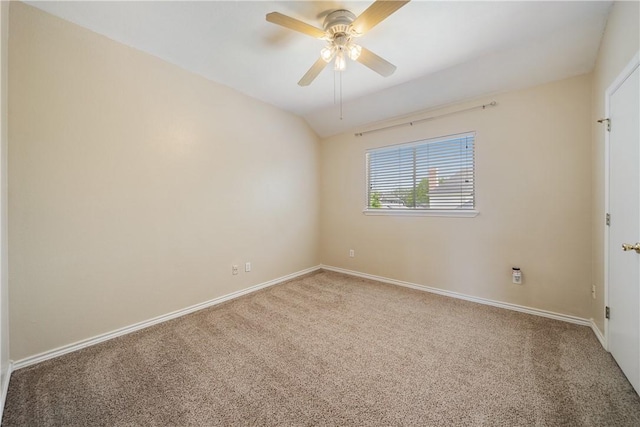 carpeted spare room with baseboards and a ceiling fan