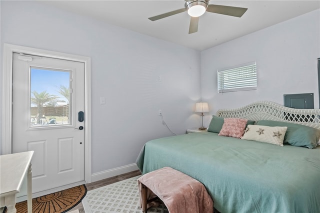 bedroom featuring multiple windows, hardwood / wood-style flooring, and ceiling fan