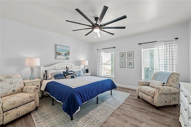 bedroom with light hardwood / wood-style flooring and ceiling fan