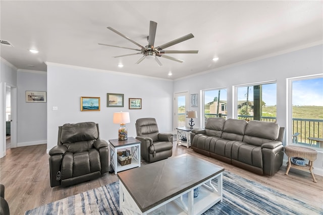 living room with ceiling fan, hardwood / wood-style flooring, and ornamental molding