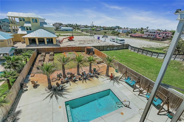 view of pool featuring a patio area and a yard