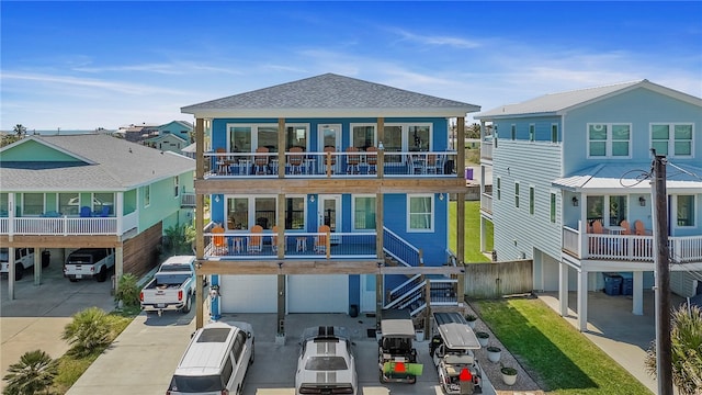 back of property with a balcony and a garage