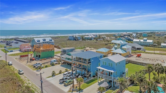 drone / aerial view featuring a water view and a view of the beach