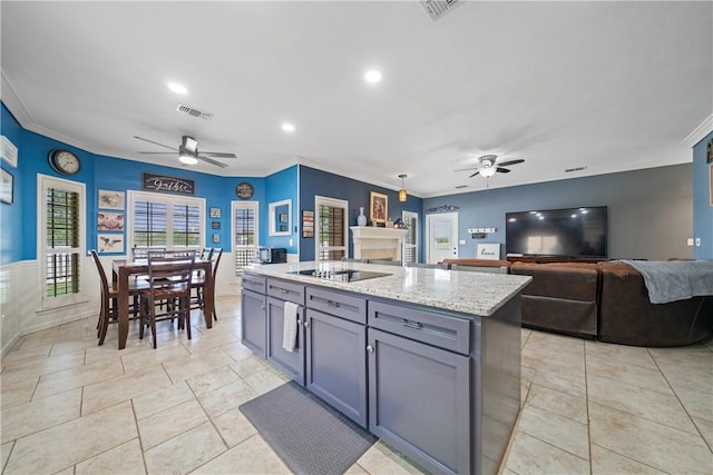 7905 Etienne Dr, Corpus Christi, TX 78414 - kitchen featuring ceiling fan, crown molding, gray cabinetry, recessed lighting, and an island with sink