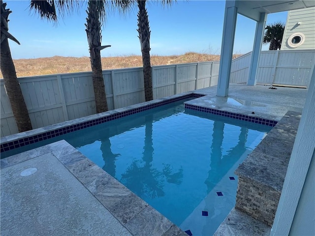 view of pool with a fenced in pool, a fenced backyard, and a patio area