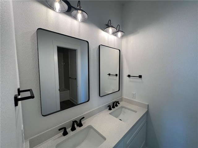 bathroom with double vanity and a sink