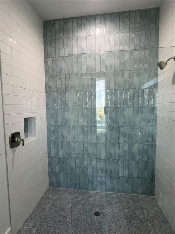 full bath featuring a tile shower