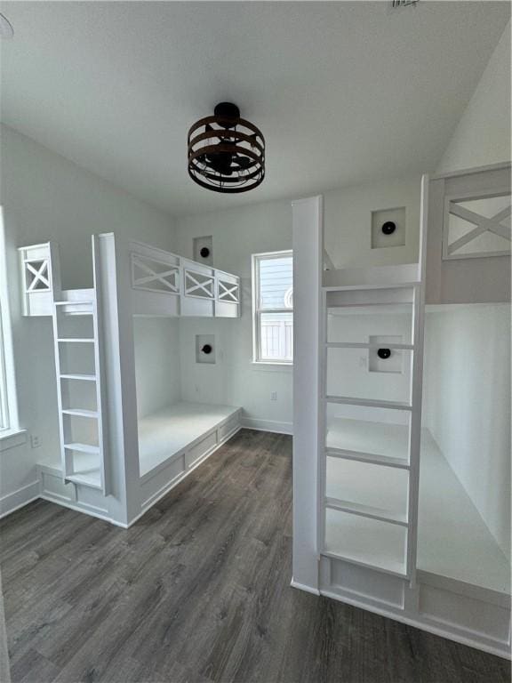 mudroom with dark wood-style floors and baseboards