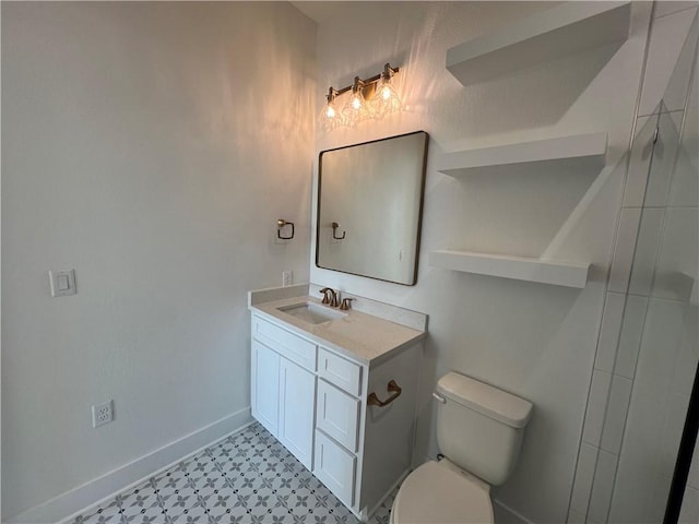 bathroom featuring vanity, tile patterned floors, toilet, and baseboards