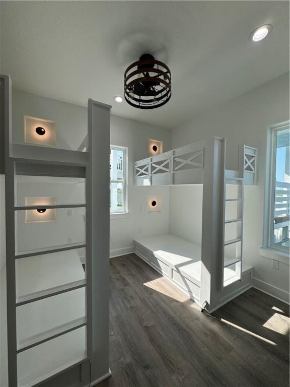 unfurnished bedroom featuring recessed lighting, baseboards, and dark wood-type flooring