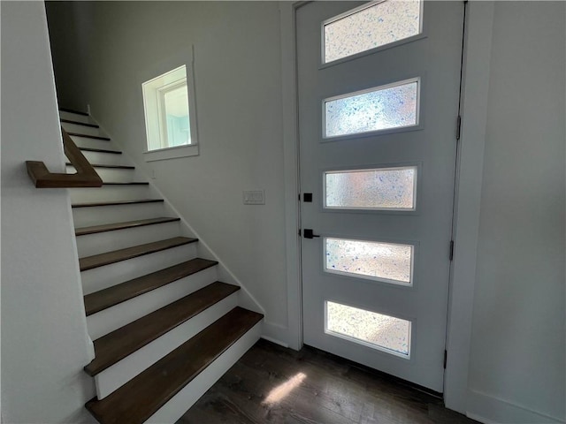 entrance foyer with stairway, baseboards, and dark wood-style flooring