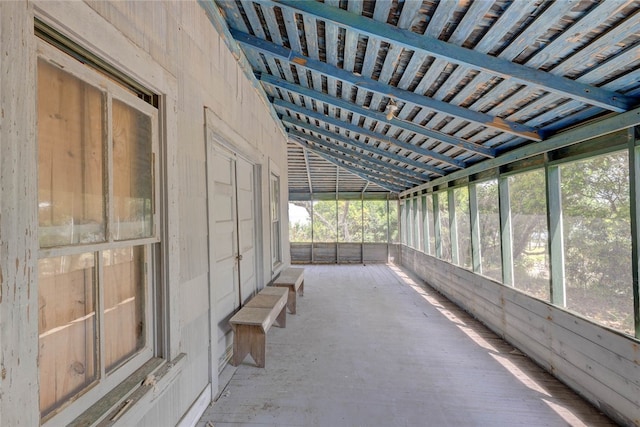 unfurnished sunroom featuring lofted ceiling