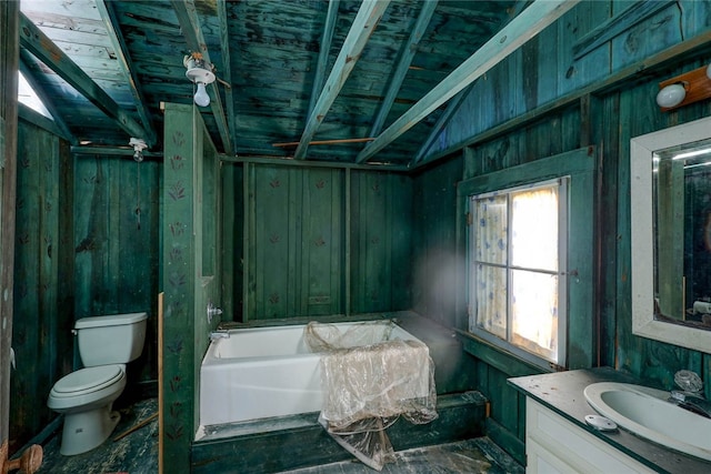 bathroom with vanity, a tub, wood walls, vaulted ceiling, and toilet