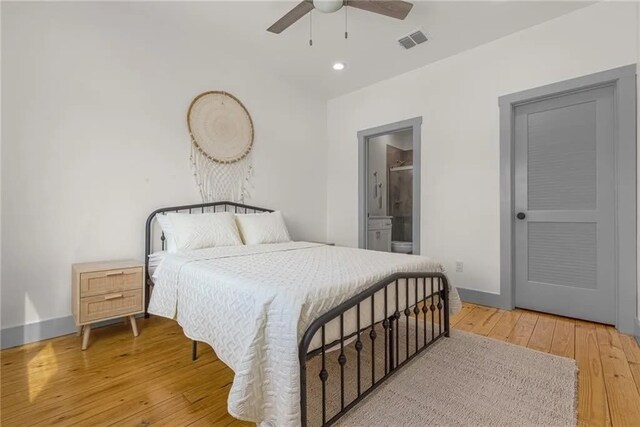 162 La Concha Blvd Unit 20, Port Aransas, TX 78373 - bedroom with wood-type flooring, connected bathroom, ceiling fan, and recessed lighting