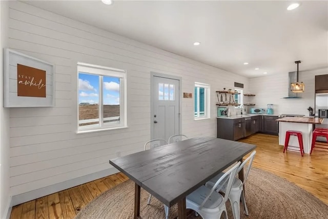 162 La Concha Blvd Unit 20, Port Aransas, TX 78373 - dining space with light wood finished floors, recessed lighting, and wood walls