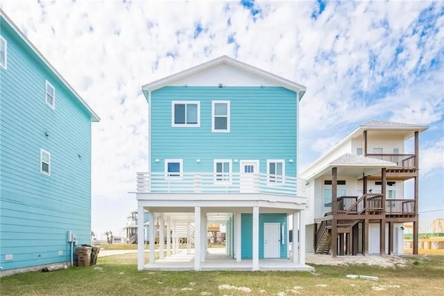 162 La Concha Blvd Unit 20, Port Aransas, TX 78373 - rear view of property featuring a balcony, a patio, and a yard