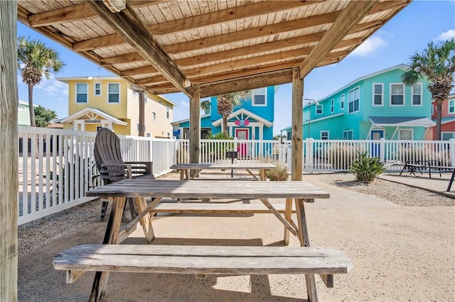 view of patio featuring a residential view, fence, and a deck