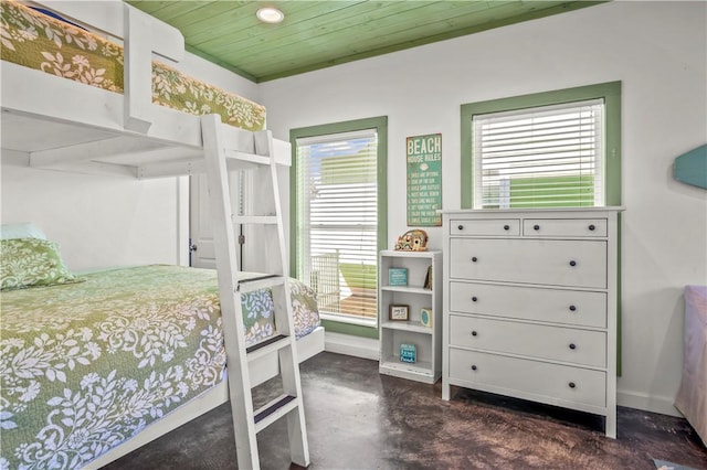 bedroom featuring wooden ceiling, baseboards, and concrete flooring