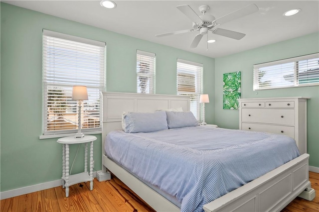 bedroom with light wood-style floors, recessed lighting, baseboards, and a ceiling fan