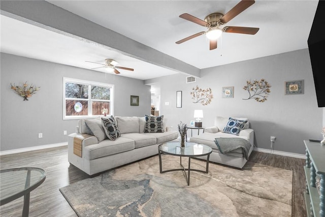 living room with hardwood / wood-style flooring, ceiling fan, and beam ceiling