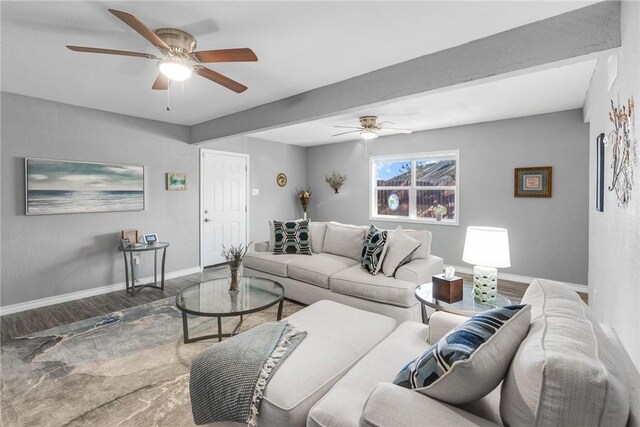 living room featuring wood-type flooring and ceiling fan