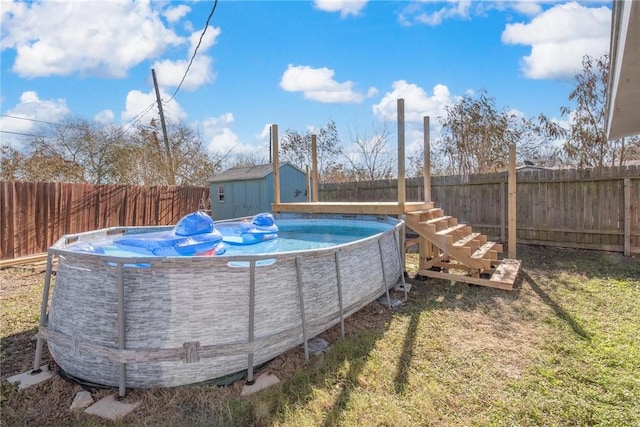 view of pool featuring a yard and a storage shed