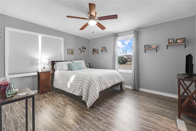 bedroom with dark wood-type flooring and ceiling fan