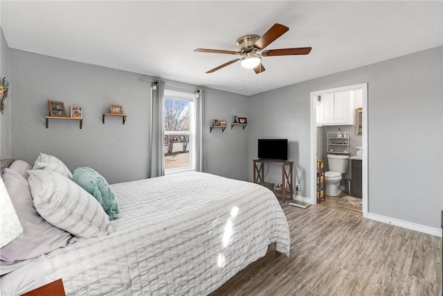 bedroom with ceiling fan, connected bathroom, and hardwood / wood-style floors