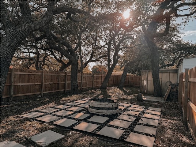 view of patio / terrace featuring an outdoor fire pit and a fenced backyard